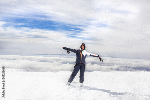 woman smile on top of a snow mountain