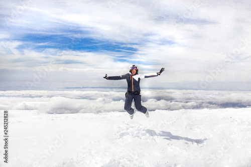 woman jump on top of a snow mountain