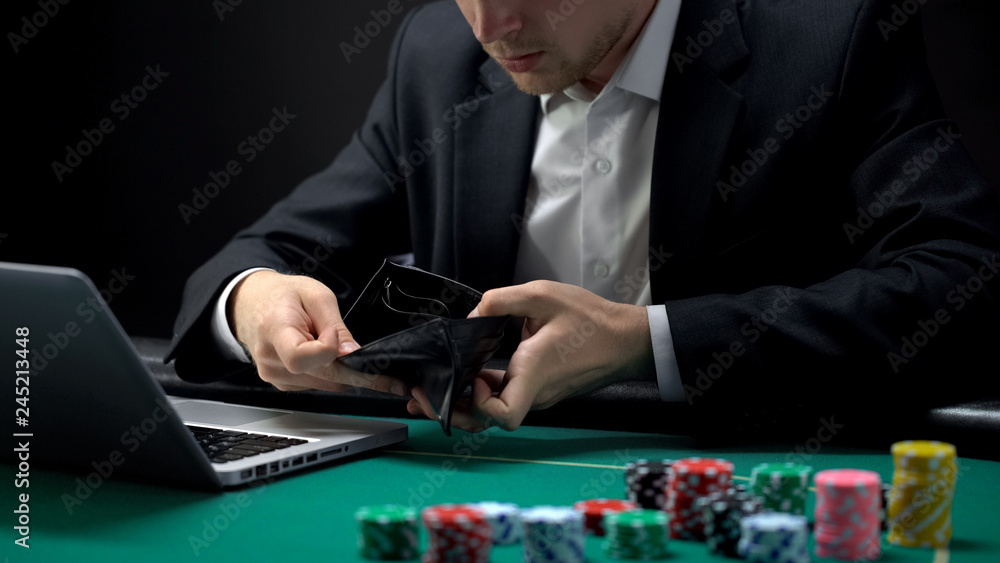 Nervous online gambler opening empty wallet, betting addiction, bankruptcy Nervous online gambler opening empty wallet, betting addiction, bankruptcy