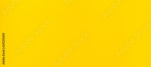 Vibrant yellow plastic surface background.