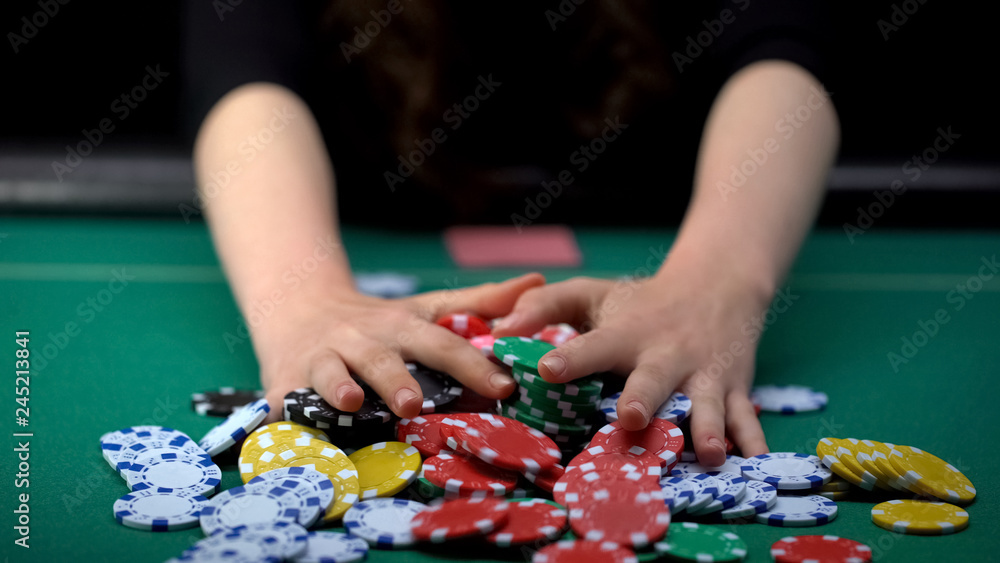 Female poker player betting all casino chips, believe in success, risky strategy Female poker player betting all casino chips, believe in success, risky strategy