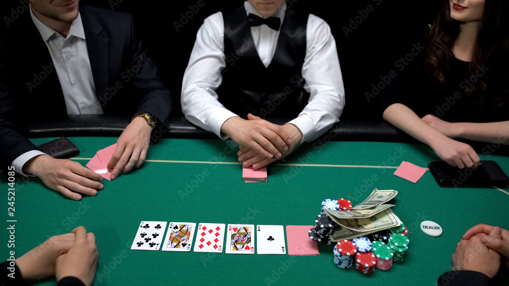 Player raising stakes putting dollars on chips at casino poker game, gambling Player raising stakes putting dollars on chips at casino poker game, gambling