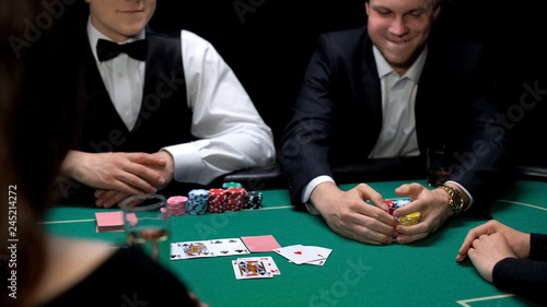 Obraz na płótnie Lucky man winning poker bet in casino, gambling business, entertainment for rich
