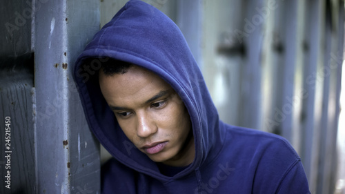 Mixed-race guy suffering from bullying, racial discrimination, cruel youth photo