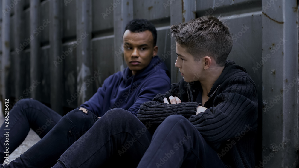 Melancholic teens escape from orphan home, hiding on backstreet, hopelessness Melancholic teens escape from orphan home, hiding on backstreet, hopelessness