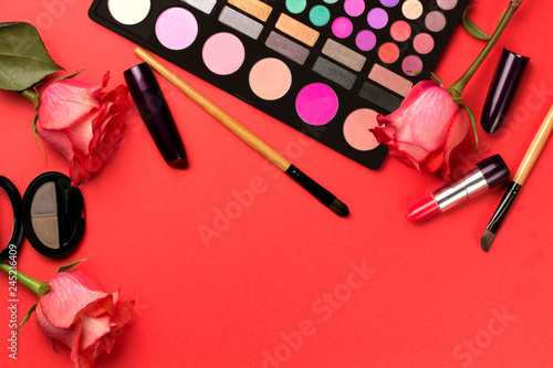 Set of cosmetics on color background with roses.