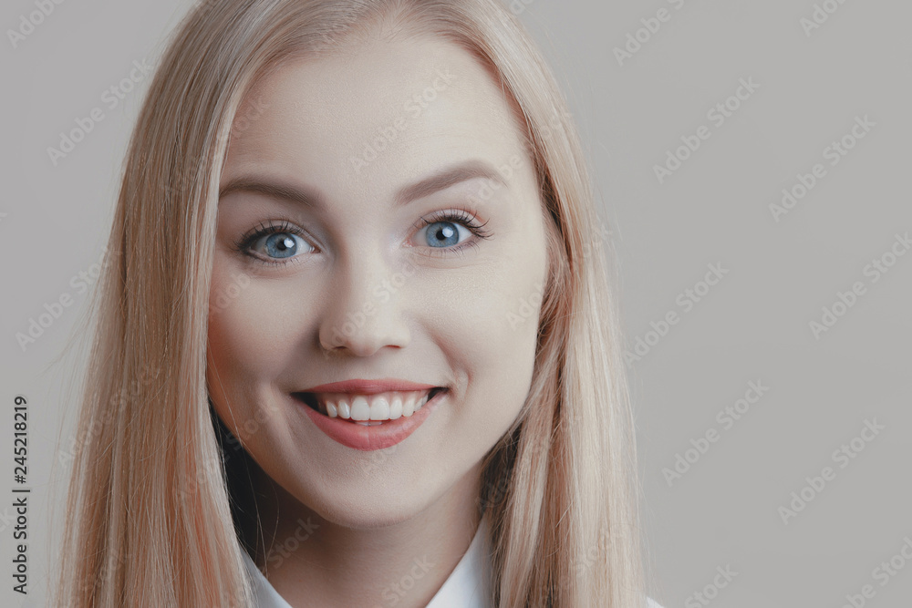 Naklejka premium Young playful cute blonde with bow tie is smiling