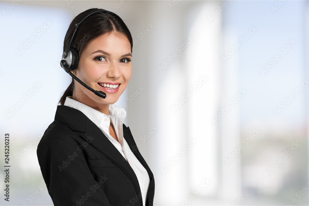 Young woman with headphones, call center or support concept Young woman with headphones, call center or support concept