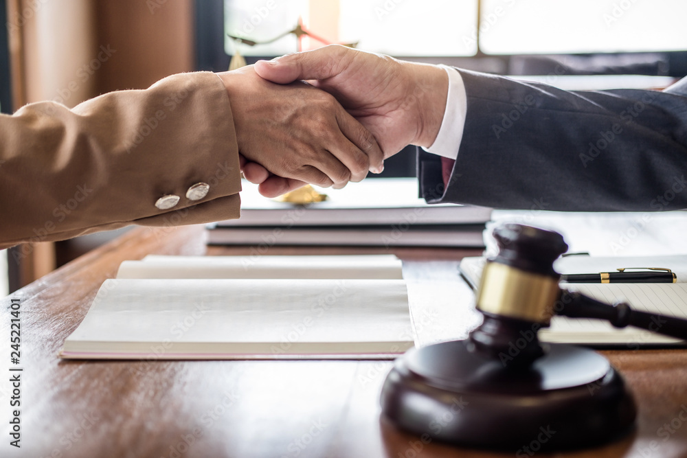 Good service cooperation of Consultation between counselor or male lawyer and business woman customer, Handshake after good deal agreement, Law and Legal concept Good service cooperation of Consultation between counselor or male lawyer and business woman customer, Handshake after good deal agreement, Law and Legal concept
