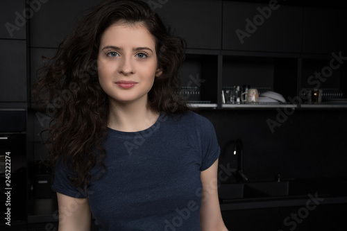 Portrait of beautiful young woman with voluminous curly hair 