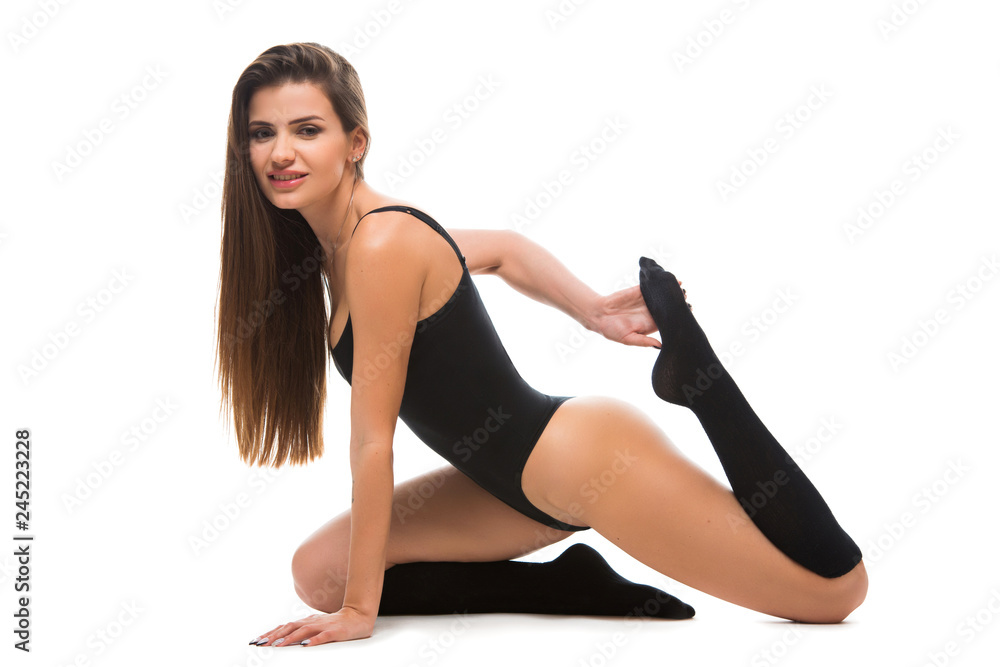 healthy fitness woman stretching before doing exercise sitting on the floor. Young female wearing a sportswear