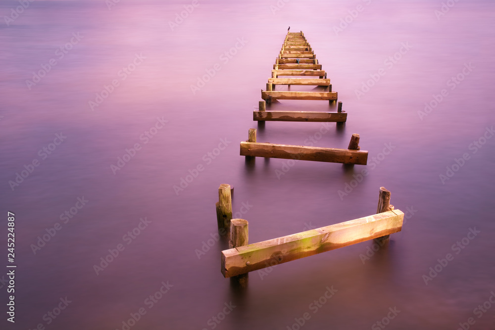 View of broken wooden pier in sea