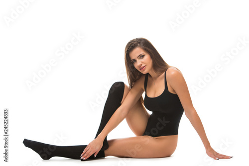 healthy fitness woman stretching before doing exercise sitting on the floor. Young female wearing a sportswear