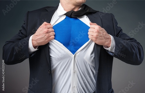 Businessman tears shirt on himself to show that he is Superman