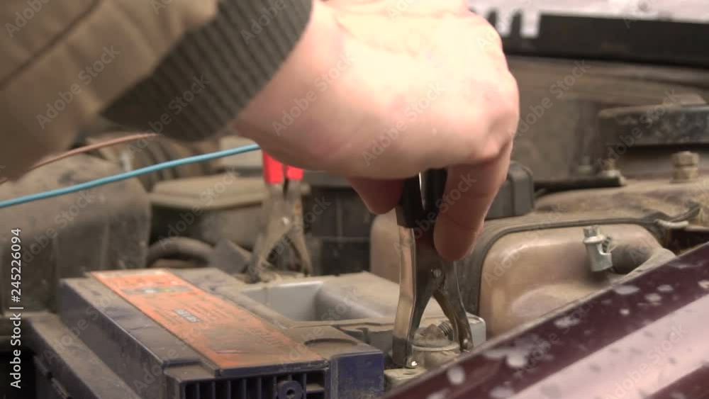 Charging The Car Battery With Red And Black Jumper Cables Charging The Car Battery With Red And Black Jumper Cables