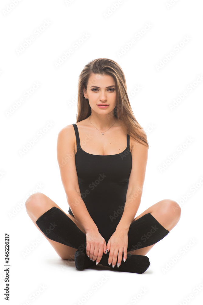 Healthy fitness woman sitting in lotus position on isolated white background. The concept of sports motivation and lifestyle Healthy fitness woman sitting in lotus position on isolated white background. The concept of sports motivation and lifestyle