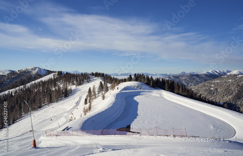 Brunnach Ski Resort, St. Oswald, Carinthia, Austria - January 20, 2019: View from the top station Brunnach to the landscaped water reservoir
