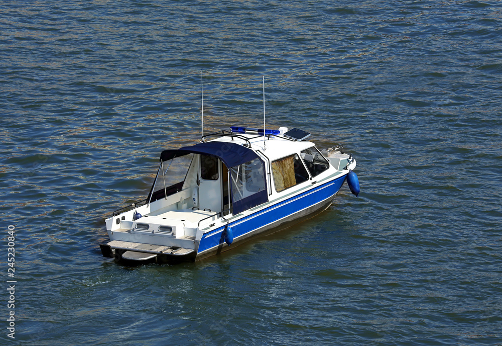 Fototapeta premium Small boat on the water, top view