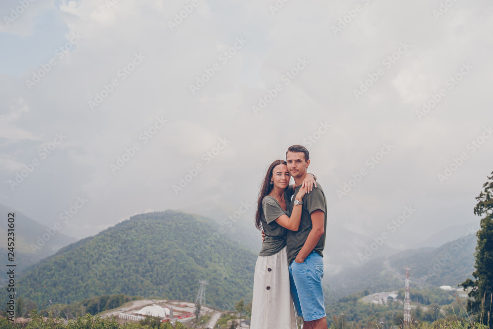 Beautiful happy family in mountains in the background of fog