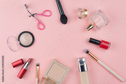 Fashion collection with accessories, flowers, cosmetics and jewelry on pink background, copyspace. Womens Day concept