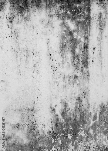 Close-up of a weathered, dirty and moldy plastered concrete wall background in black and white.