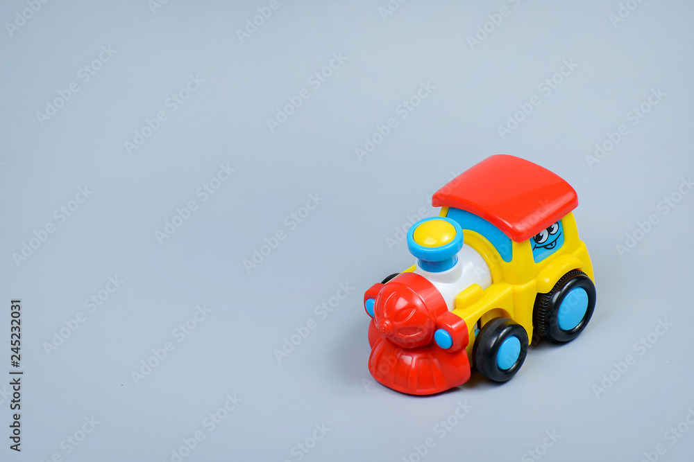 Toy locomotive on a gray background Toy locomotive on a gray background