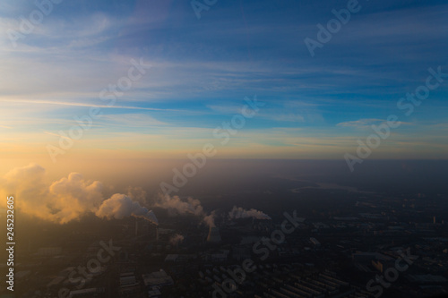 Berlin  Siemensstadt  with industrial area in front  with the river Havel and Wannsee in the background during sunrise early morning - aerial view