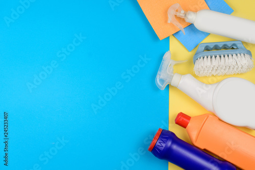 Cleaning products on a yellow background with a copyspace