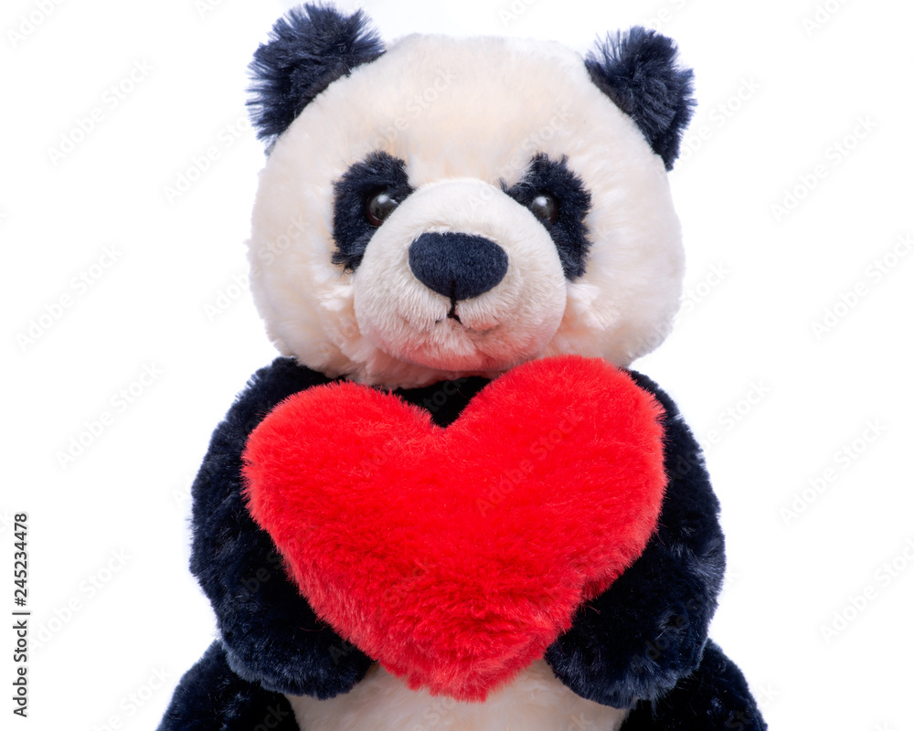 Panda bear stuffed plush toy with red fluffy heart isolated on white background. Panda bear stuffed plush toy with red fluffy heart isolated on white background.