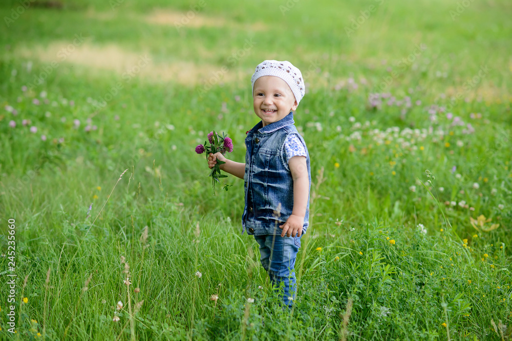 Beautiful child with flowers in spring park. Happy kid having fun outdoors. Beautiful child with flowers in spring park. Happy kid having fun outdoors.