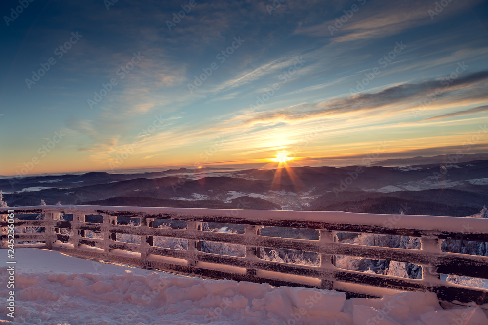 View from the terrace to the east of the sun in the mountains during the winter season.