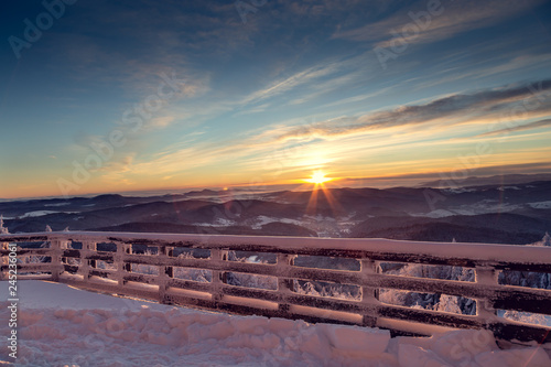 View from the terrace to the east of the sun in the mountains during the winter season.