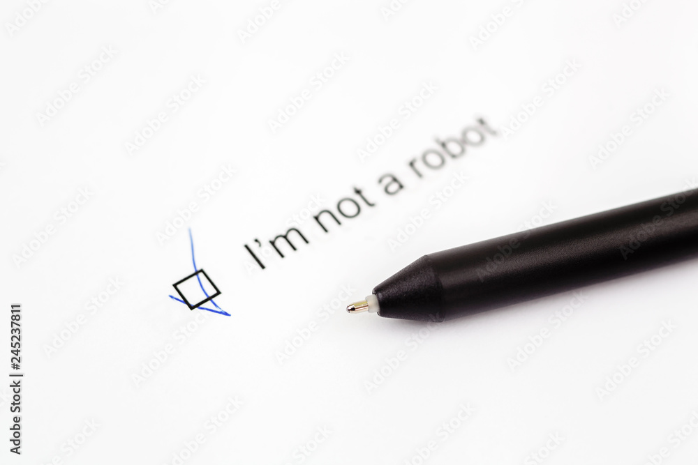 I'm not a robot - checkbox with a check mark on white paper with pen. Checklist concept I'm not a robot - checkbox with a check mark on white paper with pen. Checklist concept