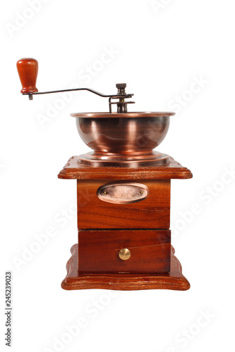 Old manual coffee grinder in brown wood case with handle on white background. Coffee grinder isolated.