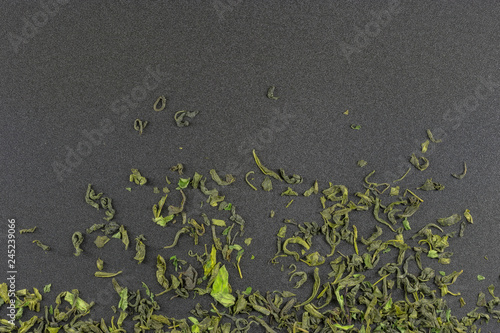 Photography tea on a gray textured background / scattered tea on a gray background photo