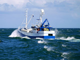 Fishing boat underway at sea to fishing grounds.