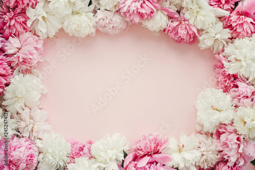 Happy mothers day floral greeting card mockup. Stylish peonies flat lay. Pink and white peonies frame on pastel pink paper with space for text. International Womens Day. Valentines day.