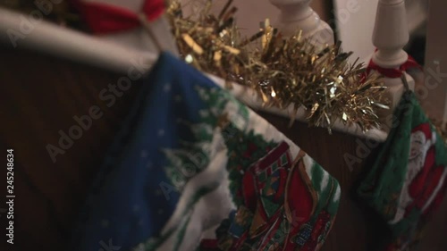 Shot on a slider passing a green and blue Christmas stocking on a staircase