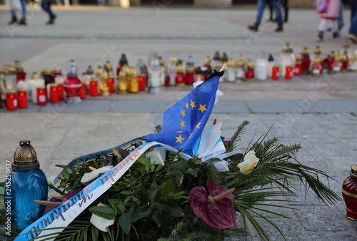 Candles on Main market square in krakow, Poland, flower funeral wreath with strip in krakow's color and flag of European union, spontanous memrioal after mureder of mayor of Gdansk Pawel Adamowicz