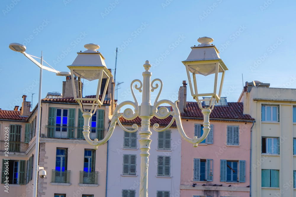 Street white iron lamp post with two led lamp on building backgrounds, Toulon, France