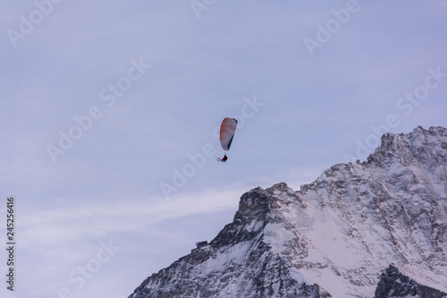 Ski paragliding over the mountains of Jungfrau region in Switzerland
