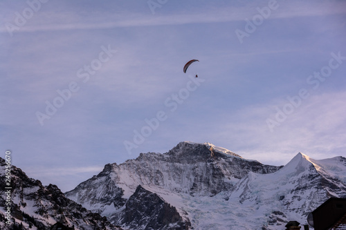 Ski paragliding over the mountains of Jungfrau region in Switzerland