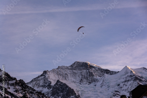Ski paragliding over the mountains of Jungfrau region in Switzerland