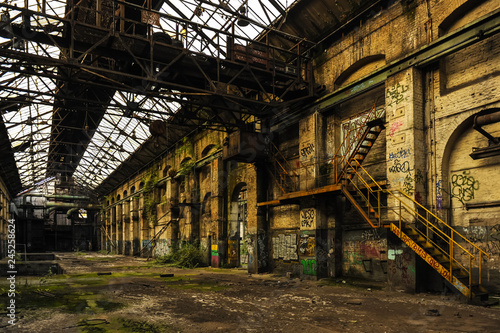 Ruined long factory with glass roof