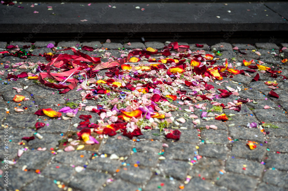 Colorful flower petals on the ground after a wedding