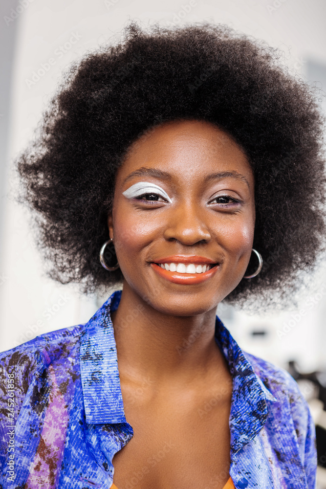 Adorable african american model in a trendy shirt feeling happy Adorable african american model in a trendy shirt feeling happy