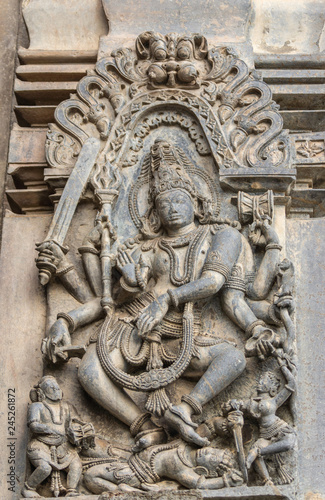 Belur, Karnataka, India - November 2, 2013: Chennakeshava Temple building. Stone statue of Gajasurasamhara, Lord Shiva slaying the demon under his feet. 