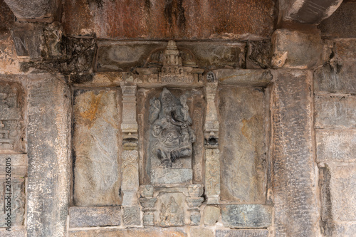 Belur, Karnataka, India - November 2, 2013: Chennakeshava Temple building. Stone statue of Ganesha, son of Lord Shiva. with well carrested trunk and legs.