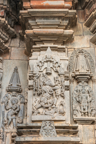 Belur, Karnataka, India - November 2, 2013: Chennakeshava Temple. Gray wall stone panel sculpture of Lord Vishnu as his boar avatar. Smaller him again in classic pose, and a dancing girl, a Shilabalik © Klodien