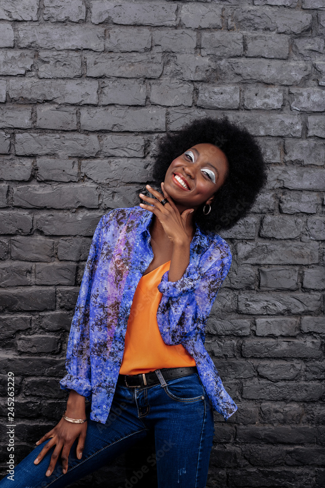 Dark-haired beautiful model in blue jeans looking amazing Dark-haired beautiful model in blue jeans looking amazing